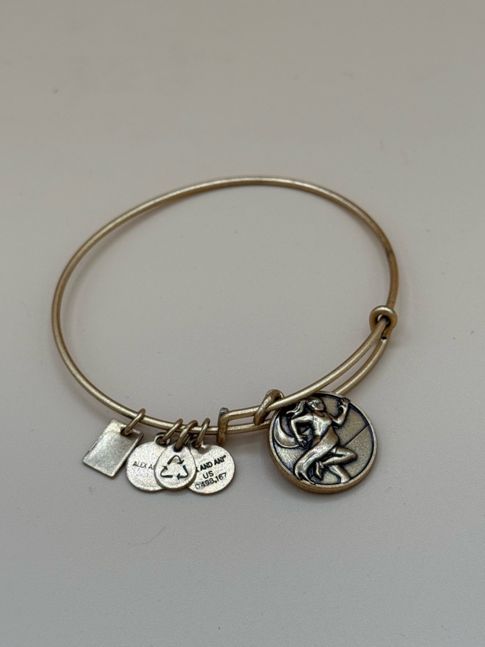 Alex and Ani Gold Tone Charm Bangle with Track and Field charm